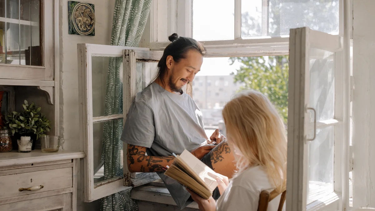 Woman in gray long sleeve shirt reading book
