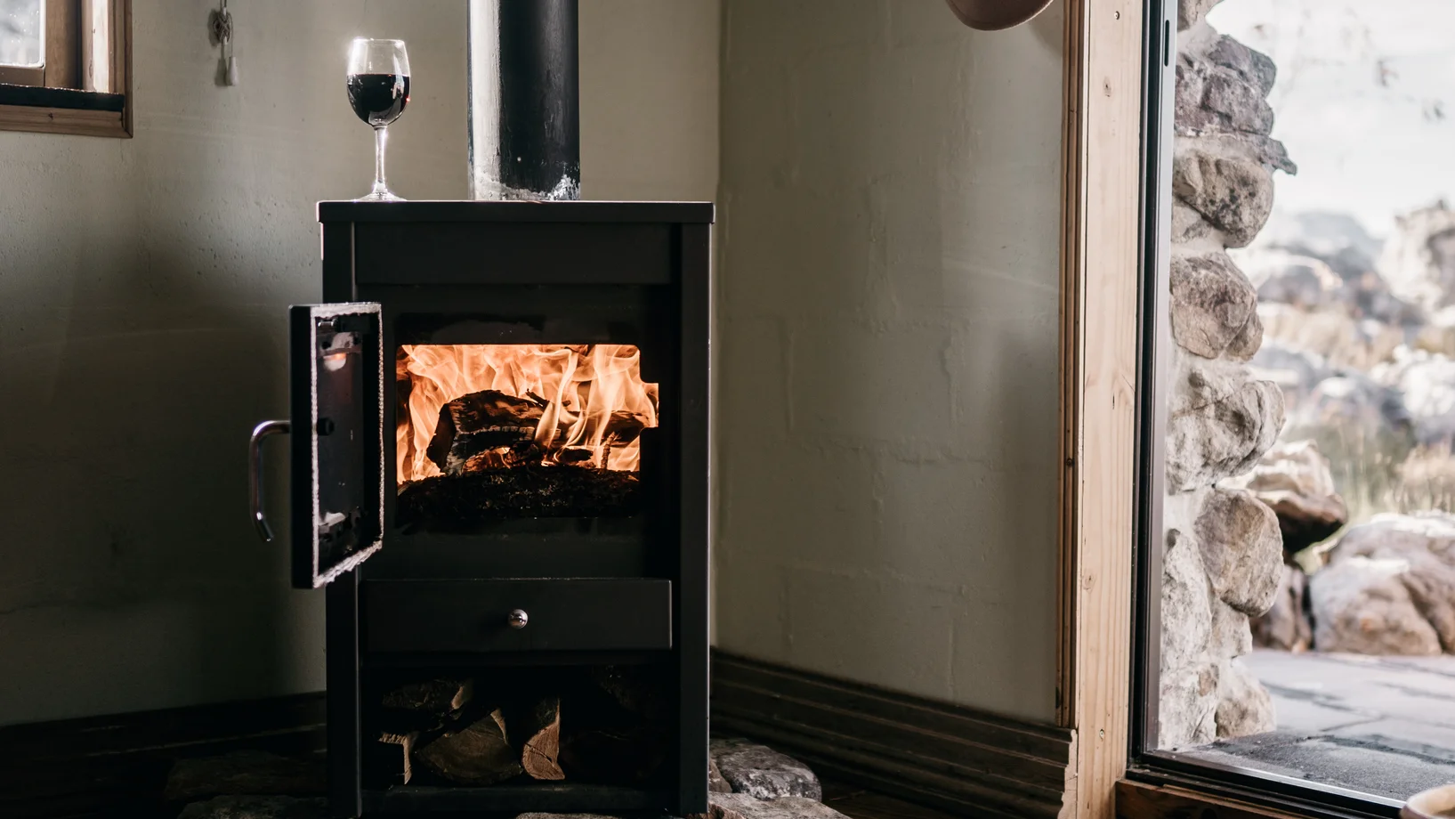 Wood burning stove on corner side of a house