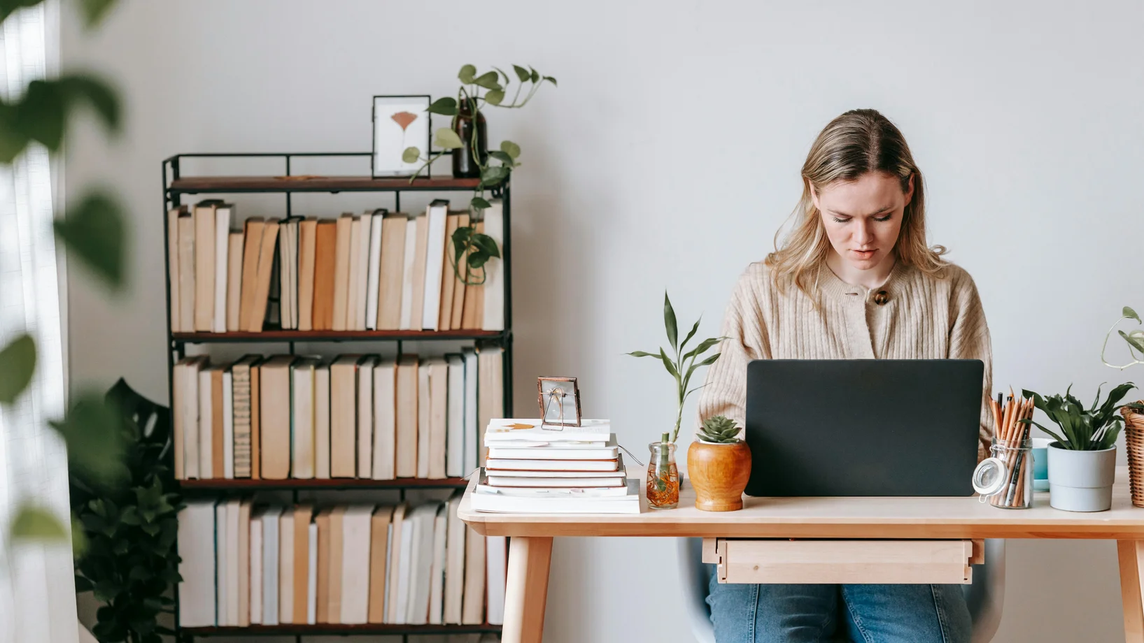 Concentrated freelancer working on laptop at home desk