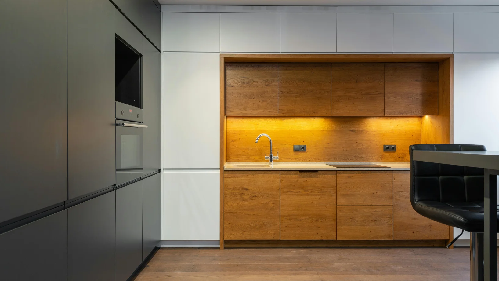 Explore a sleek and contemporary kitchen with wood accents and ample lighting.