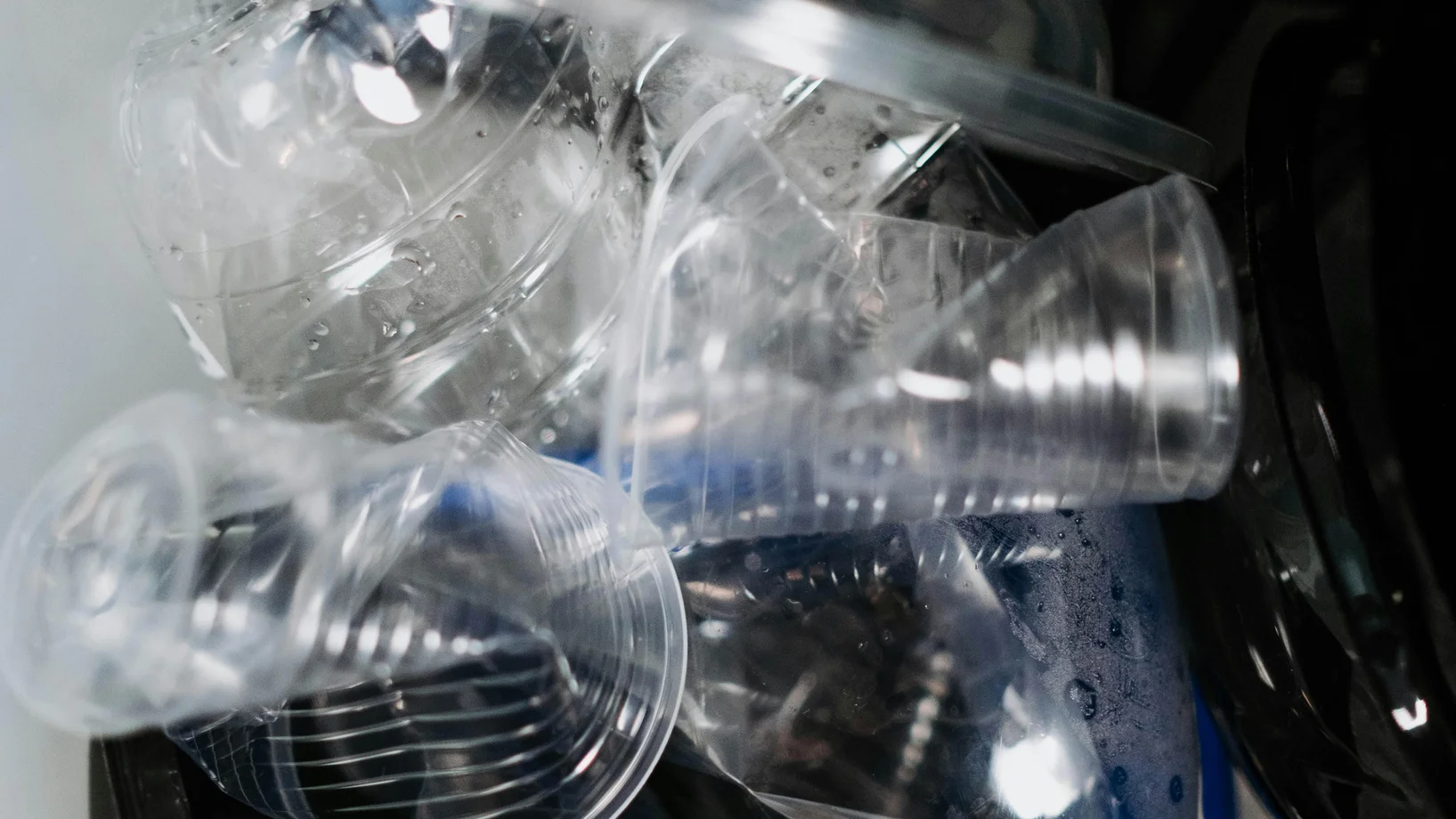 Close-up of plastic waste in a recycling bin, highlighting environmental concerns.