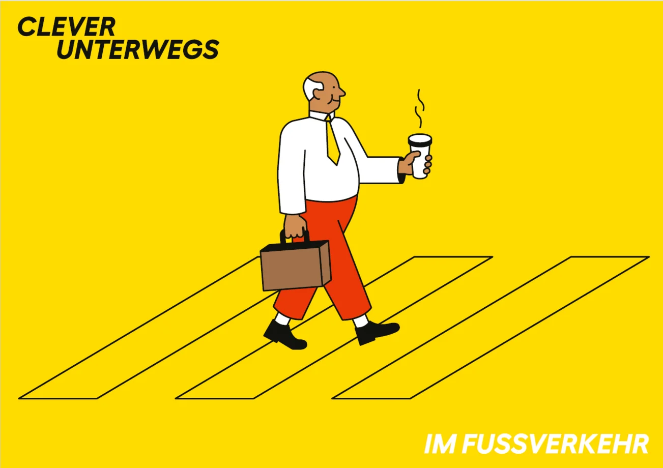 Mann geht über Fussgängerstreifen mit Kaffee in der Hand